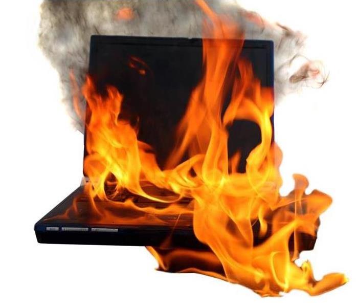 Burning laptop on a desk