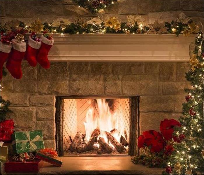 Fireplace with fire and Stockings hanging from the mantle