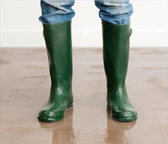 Man standing with wading boots on. 